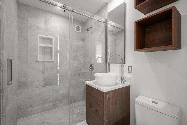 a bathroom with a sink toilet and shower