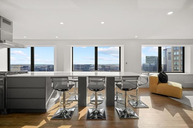 a living room with furniture and floor to ceiling windows