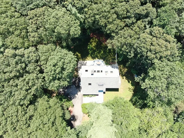 a white house with lots of trees