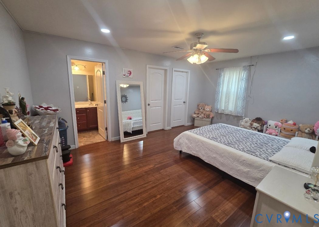 4504 Warwick Road Richmond, VA 23234 - Photo 11 of 15 a spacious bedroom with a bed and wooden floor