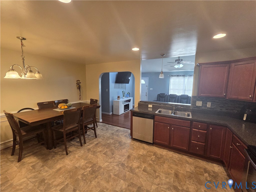4504 Warwick Road Richmond, VA 23234 - Photo 5 of 15 a kitchen with stainless steel appliances granite countertop a sink a stove a dining table and chairs