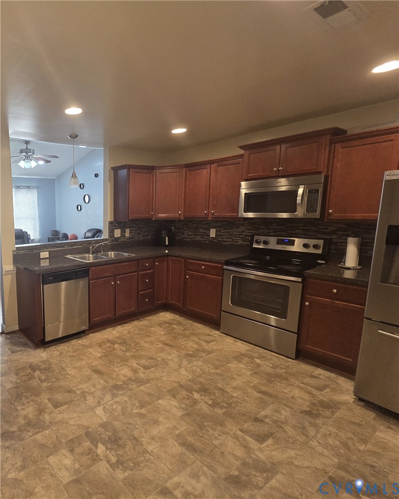 4504 Warwick Road Richmond, VA 23234 - Photo 6 of 15 a kitchen with stainless steel appliances granite countertop a stove and a sink