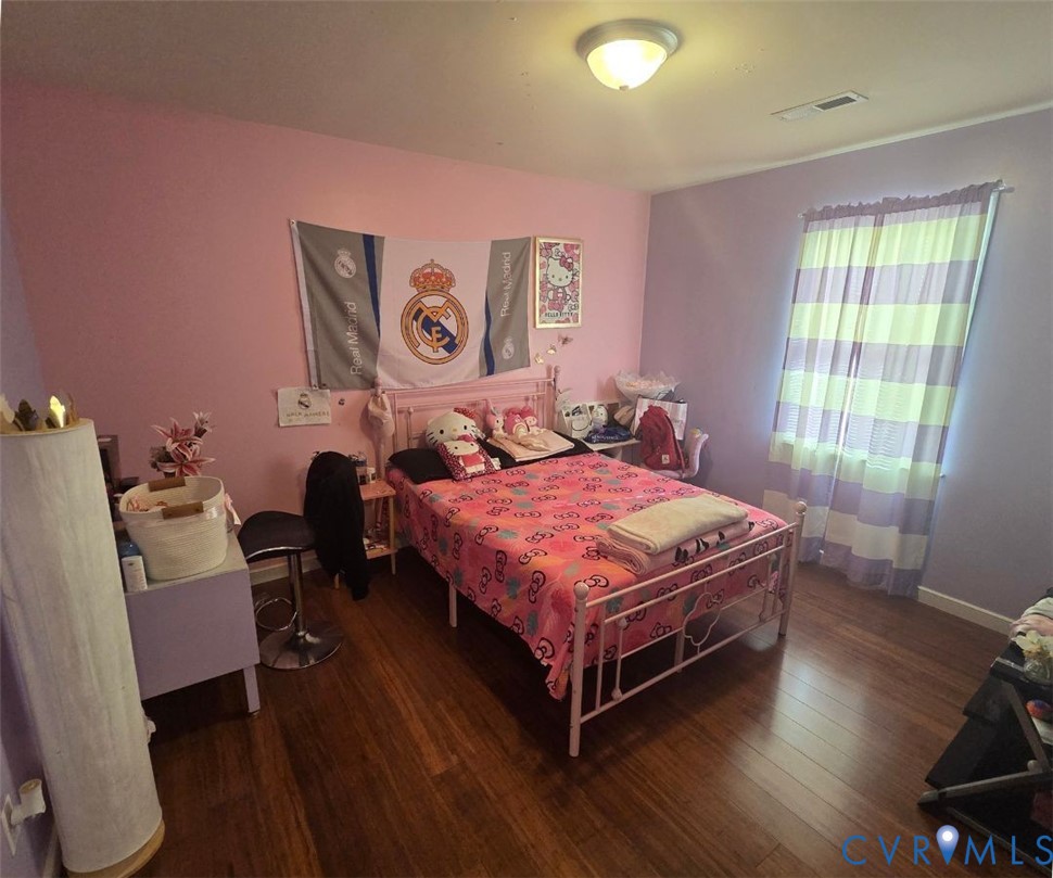 4504 Warwick Road Richmond, VA 23234 - Photo 10 of 15 a bedroom with a bed and wooden floor