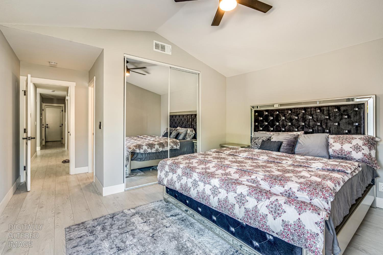 2 Rio Campo Court Sacramento, CA 95834 - Photo 13 of 24 a bedroom with a large bed and a chandelier