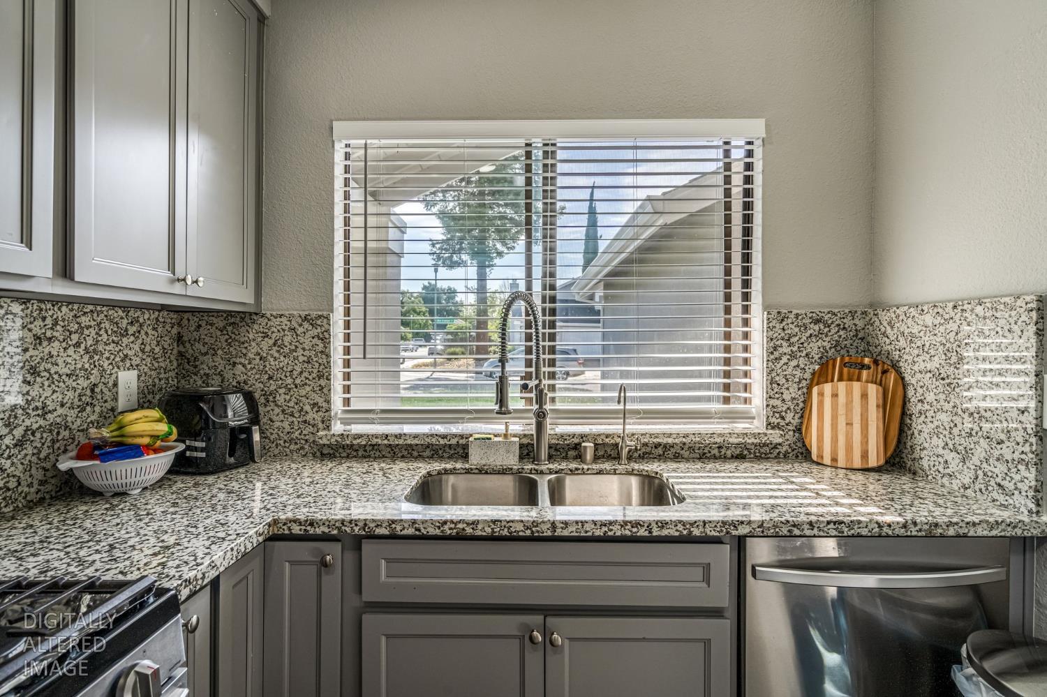 2 Rio Campo Court Sacramento, CA 95834 - Photo 10 of 24 a kitchen with granite countertop a sink and a white wooden cabinets