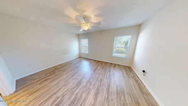a view of a room with wooden floor