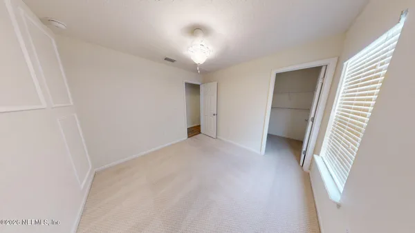 a view of a patio with couches table and chairs under an umbrella
