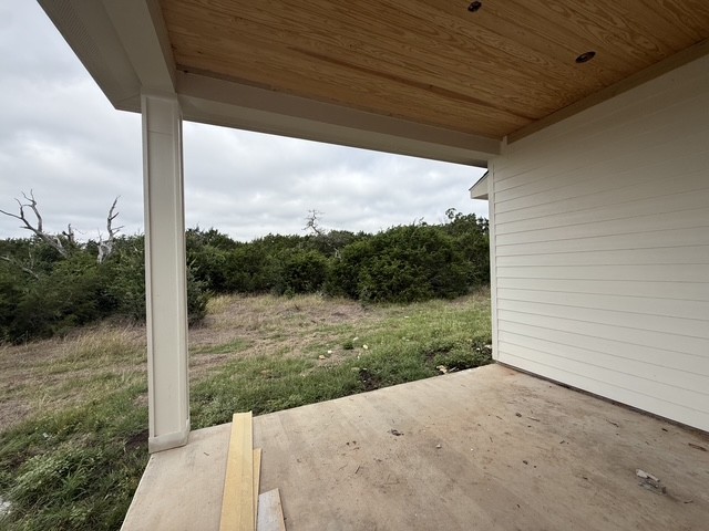127 Riparian Elms Road Bertram, TX 78605 - Photo 18 of 22 A spacious covered patio offers a private natural backdrop.