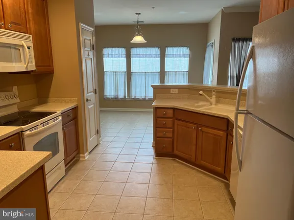 a kitchen with a stove a sink and a refrigerator