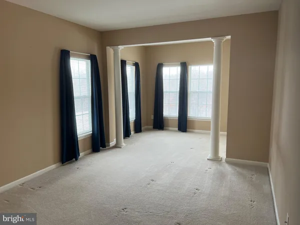 an empty room with windows and closet