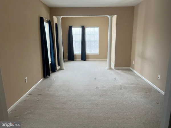 an empty room with windows and closet