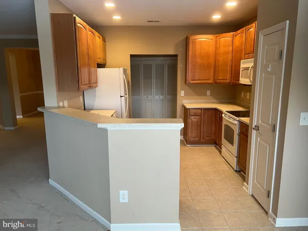 a kitchen with a refrigerator sink and stove