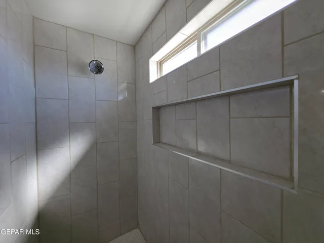 a bathroom with a glass shower door