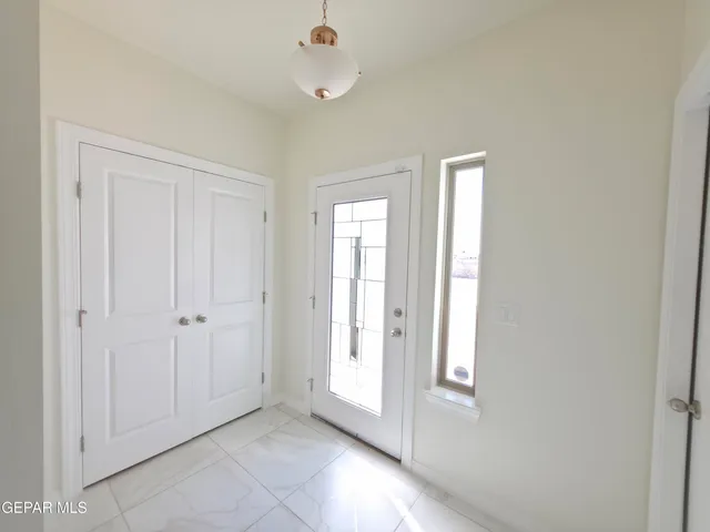 an empty room with windows and closet area