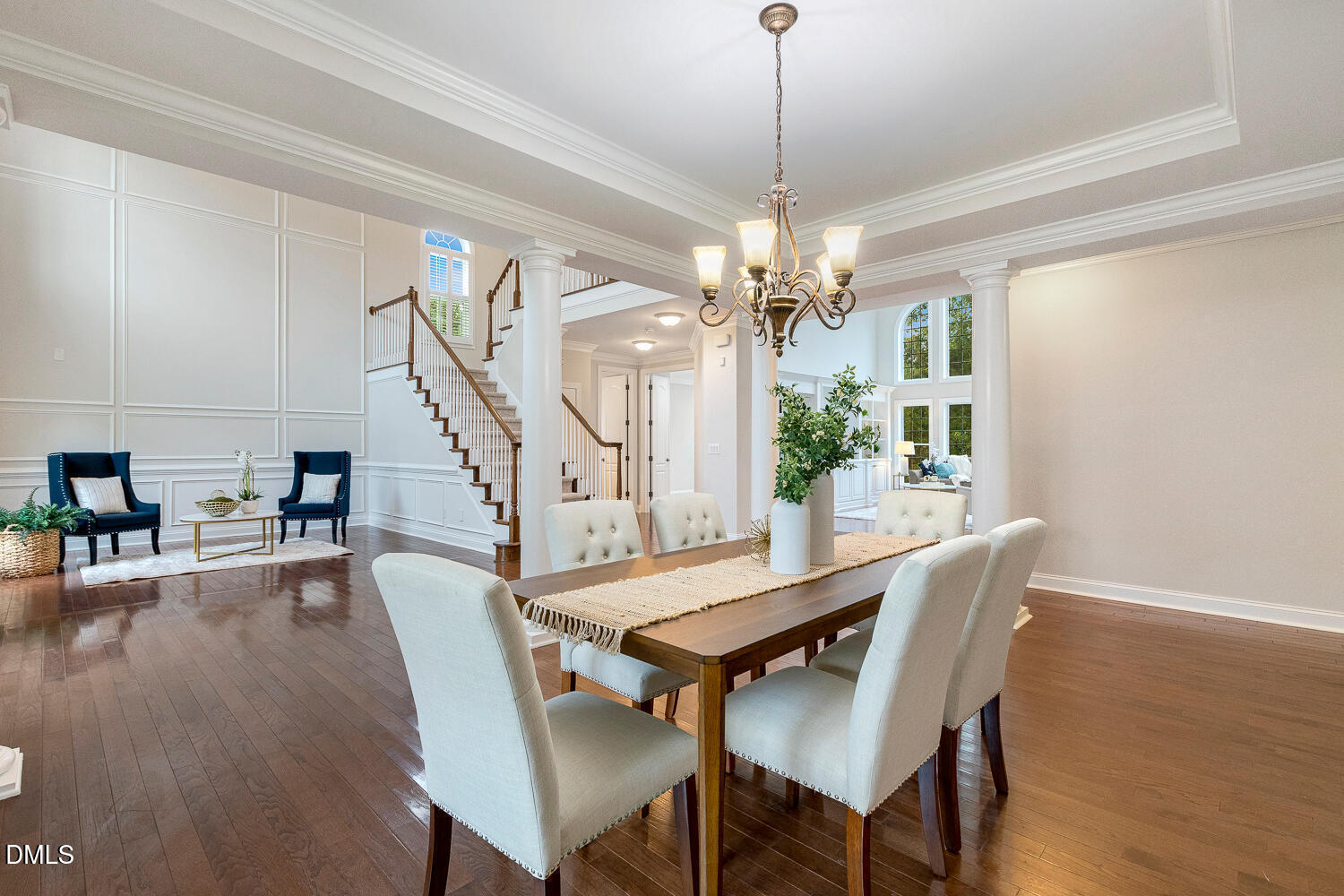 404 Vintage Hill Circle Apex, NC 27539 - Photo 15 of 82 a dining room with wooden floor a chandelier a wooden table and chairs