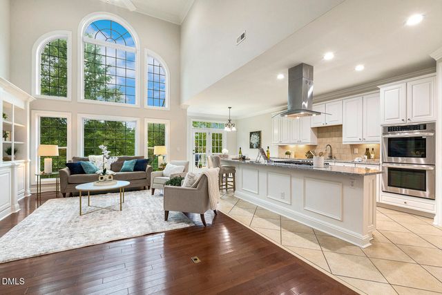 a view of a dining room with furniture and chandelier
