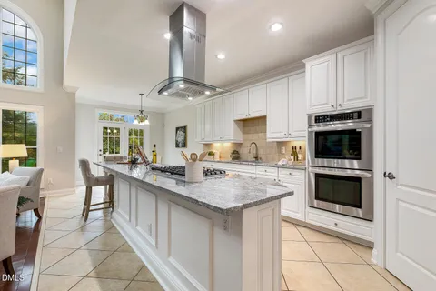 a spacious bedroom with a bed and a large window