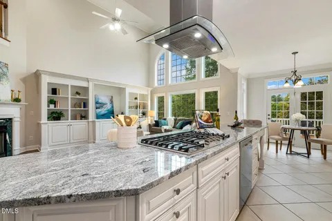 a spacious bedroom with a bed and a chandelier