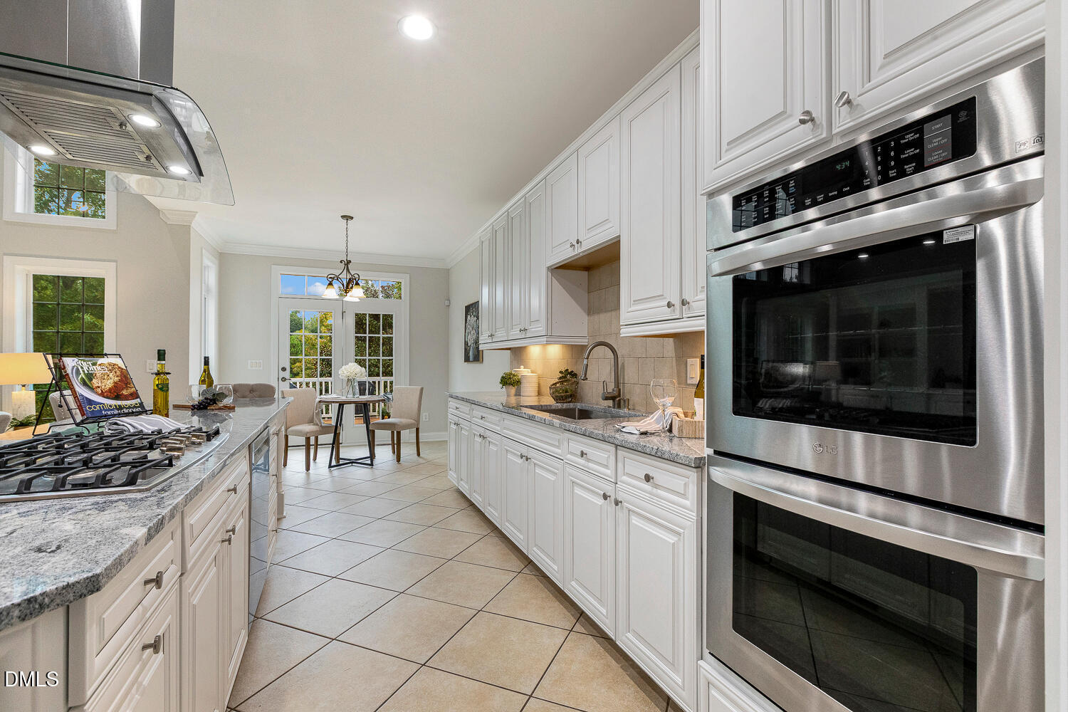 404 Vintage Hill Circle Apex, NC 27539 - Photo 26 of 82 a kitchen with stainless steel appliances kitchen island granite countertop a stove microwave and cabinets