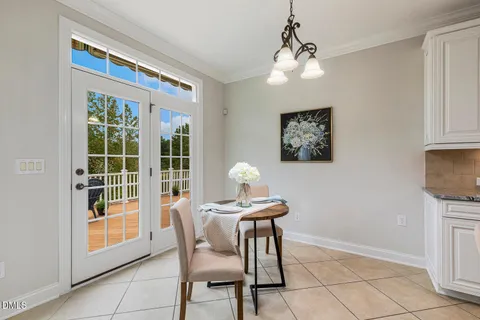 a view of a livingroom with a chandelier fan and entryway