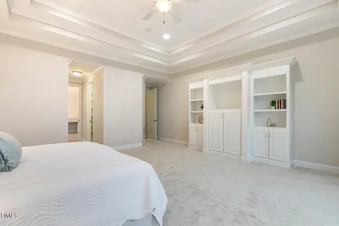 an empty room with window and a ceiling fan