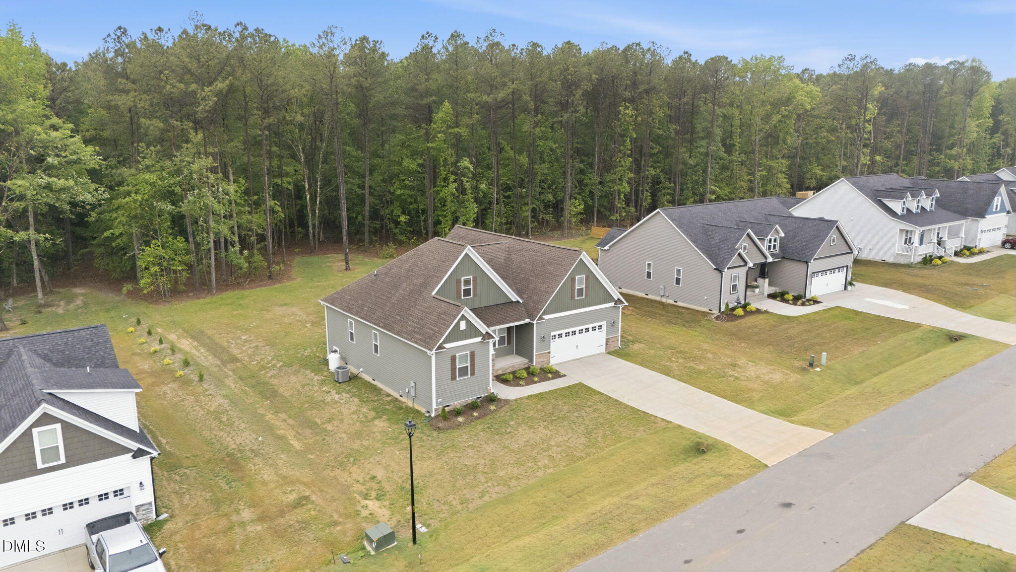 146 Seahawk Way Zebulon, NC 27597 - Photo 46 of 51 a view of a big house with a yard and mountain view
