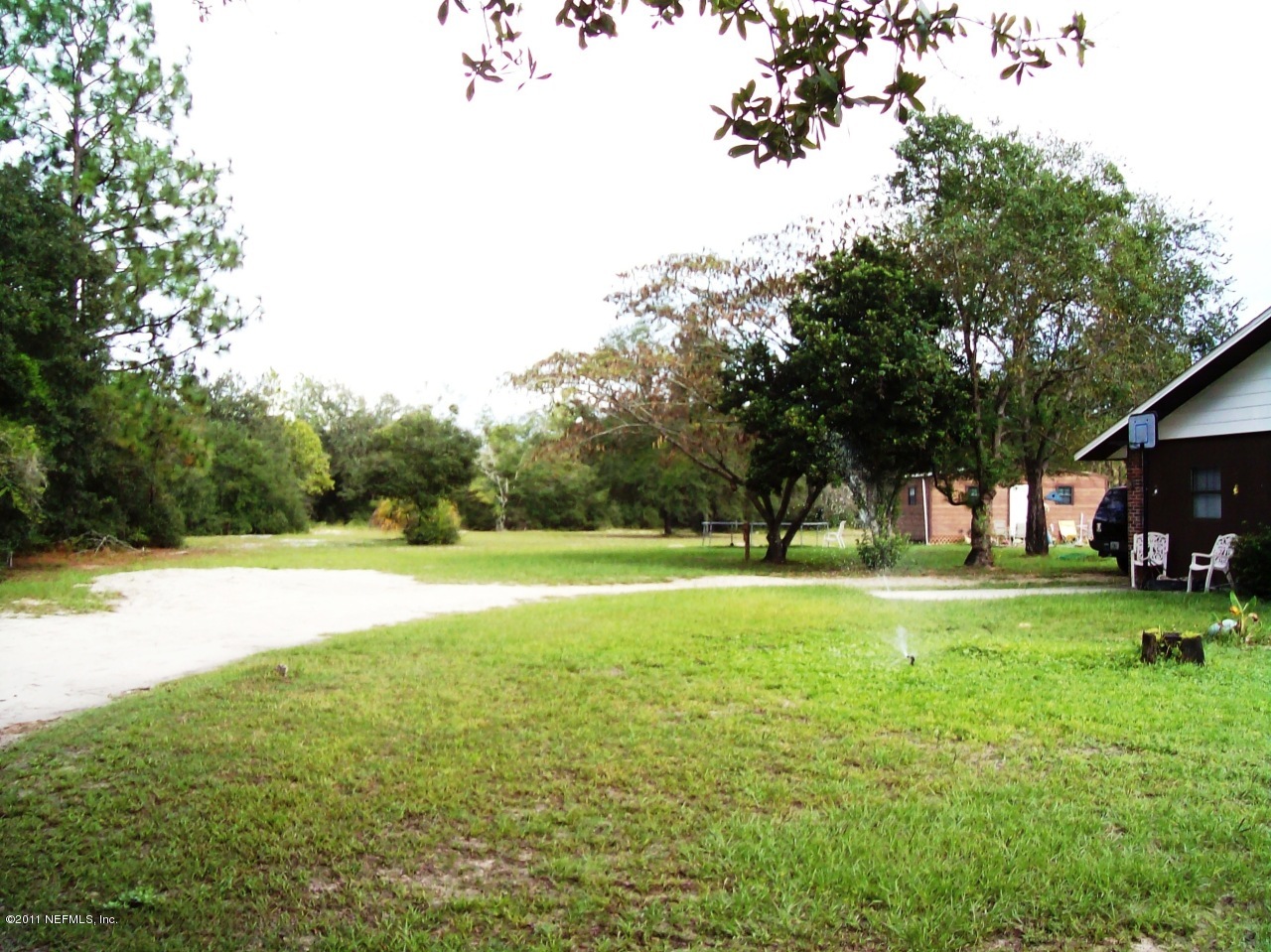 7715 Ranchette Road Keystone Heights, FL 32656 - Photo 2 of 32 a view of pool and trees in the background