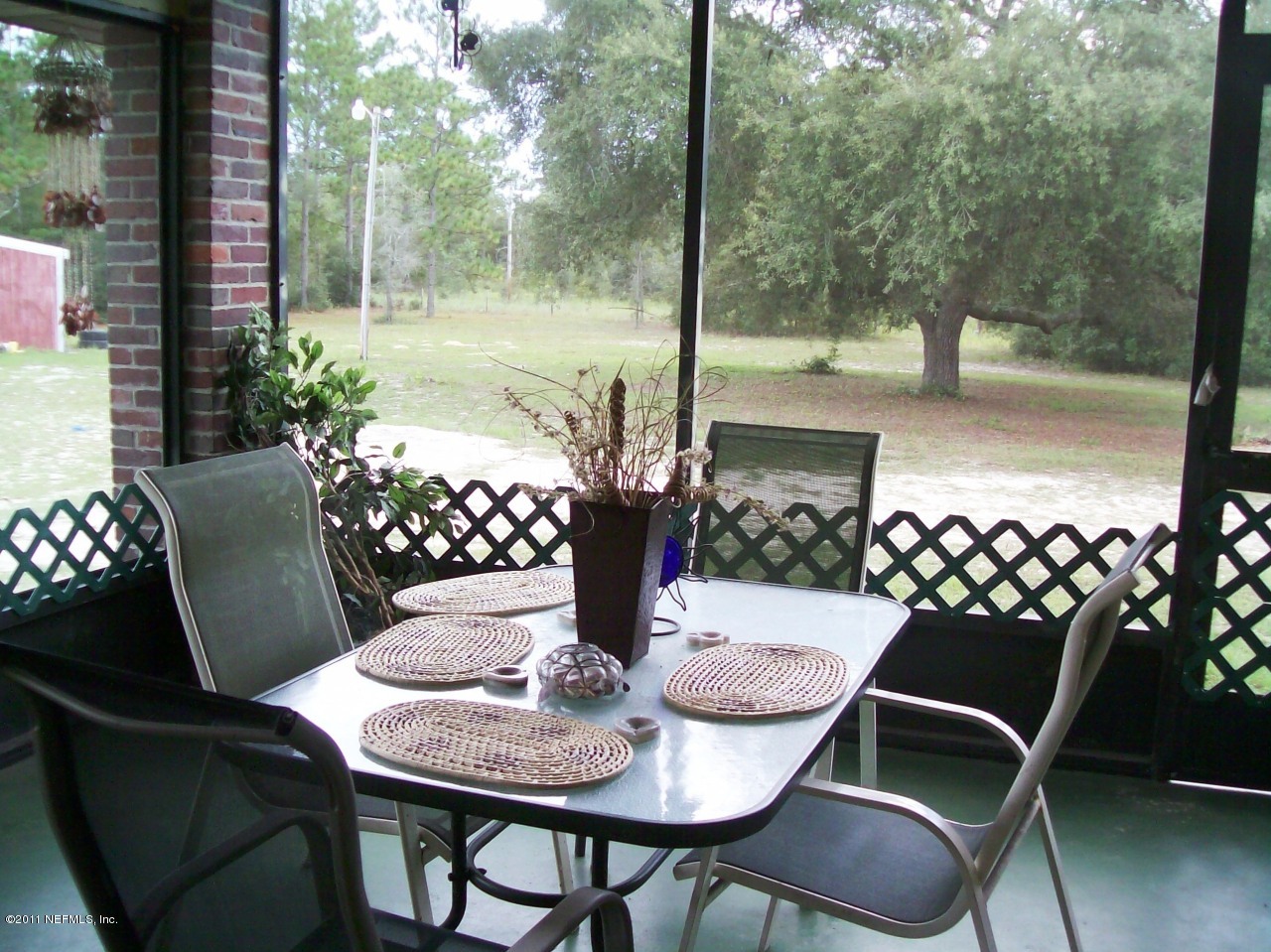 7715 Ranchette Road Keystone Heights, FL 32656 - Photo 24 of 32 a view of a dining room with furniture window and wooden floor