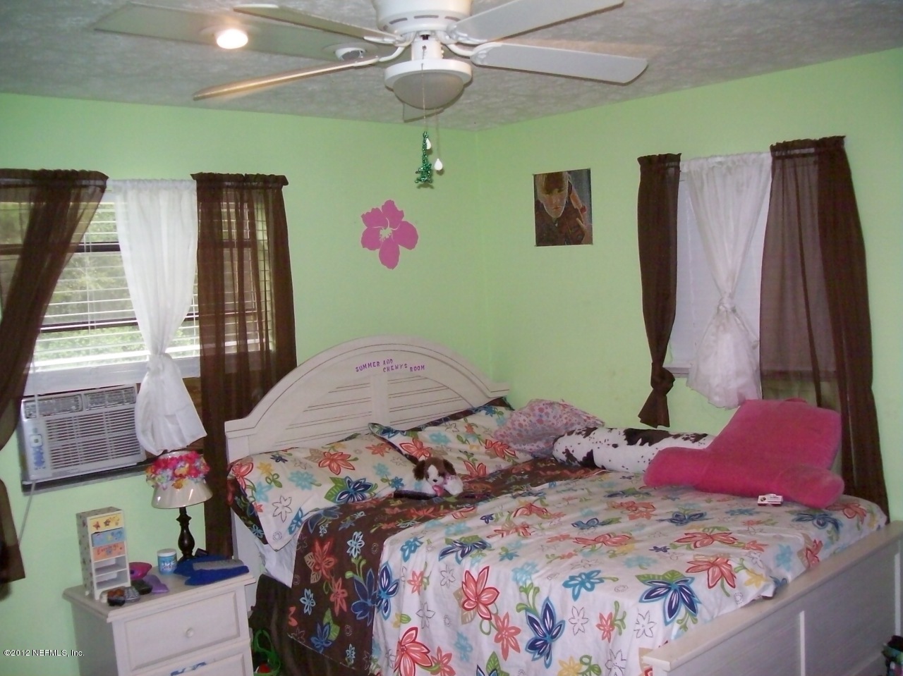 7715 Ranchette Road Keystone Heights, FL 32656 - Photo 28 of 32 a bedroom with a bed and a chandelier