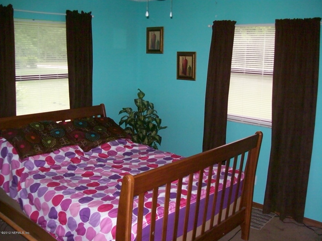 7715 Ranchette Road Keystone Heights, FL 32656 - Photo 32 of 32 a bedroom with a bed and a flat tv screen on dresser