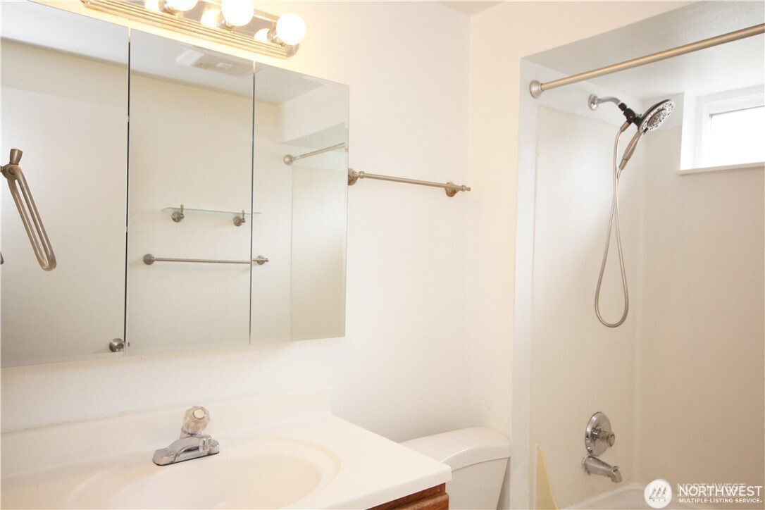 2413 Southwest Graham Street Seattle, WA 98106 - Photo 8 of 10 a bathroom with a sink and a shower