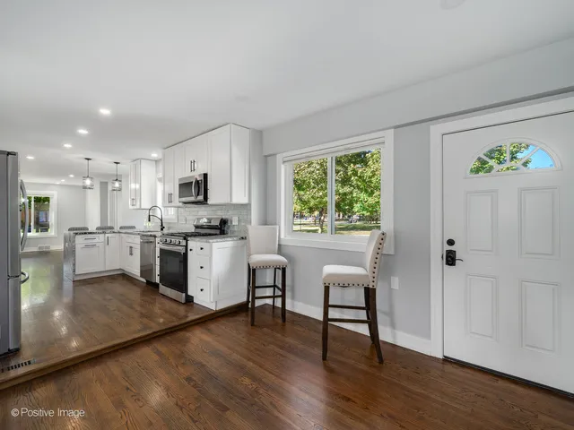 a kitchen with a refrigerator and a stove top oven