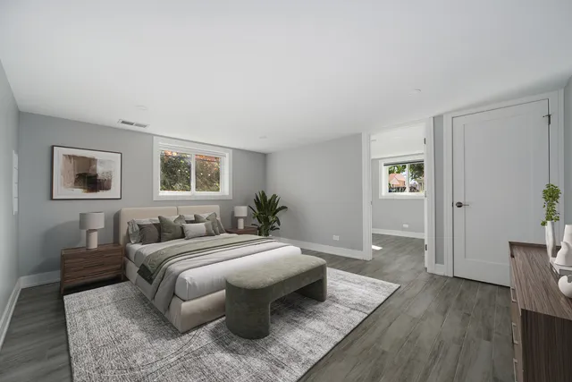 a bedroom with a large bed and a wooden floor