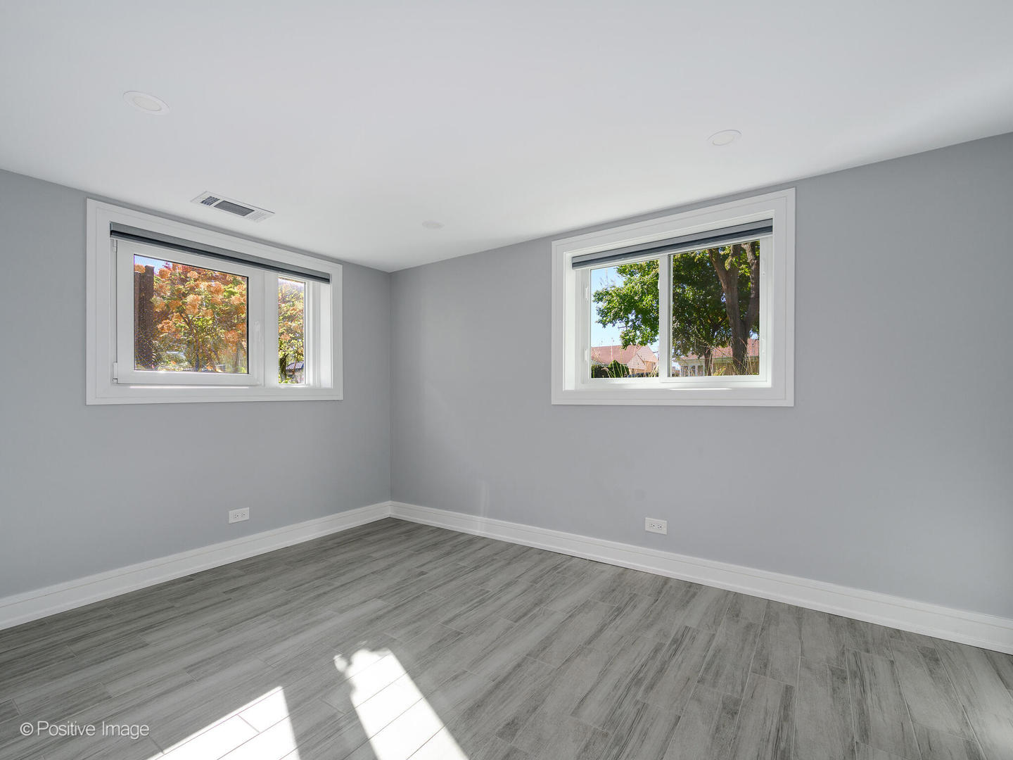 7225 East Prairie Road Lincolnwood, IL 60712 - Photo 20 of 27 a view of empty room with wooden floor and fan