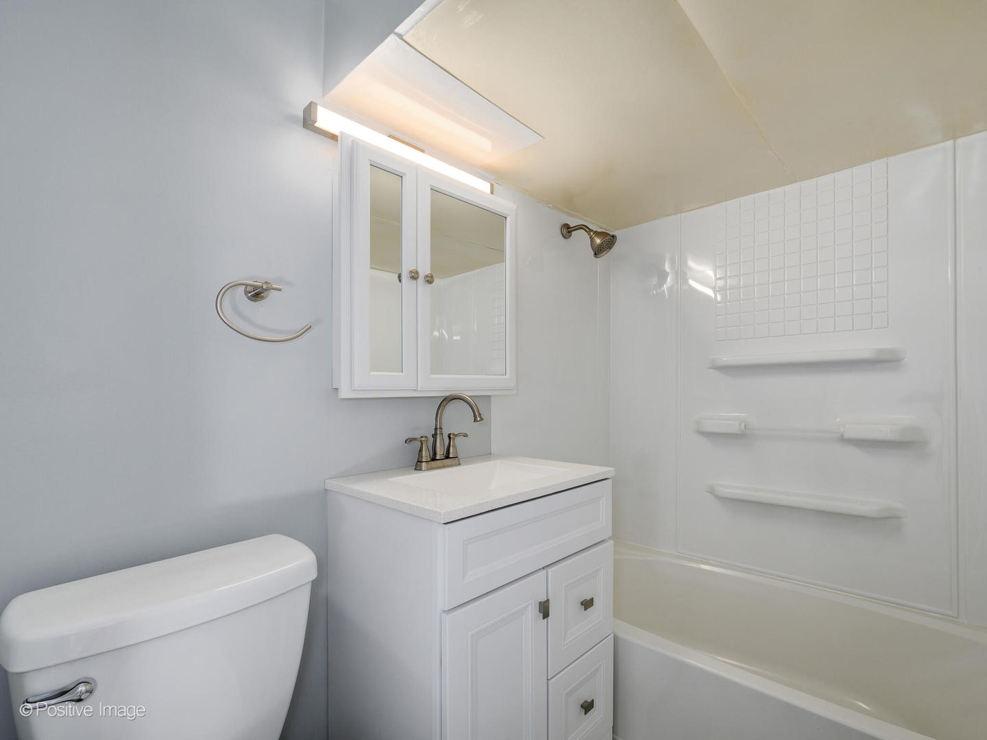 7225 East Prairie Road Lincolnwood, IL 60712 - Photo 22 of 27 a bathroom with a toilet sink and mirror