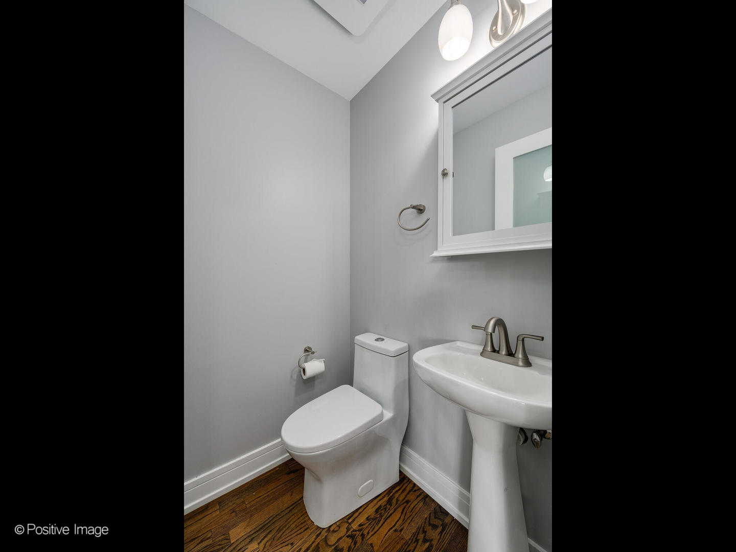 7225 East Prairie Road Lincolnwood, IL 60712 - Photo 23 of 27 a bathroom with a toilet sink and mirror