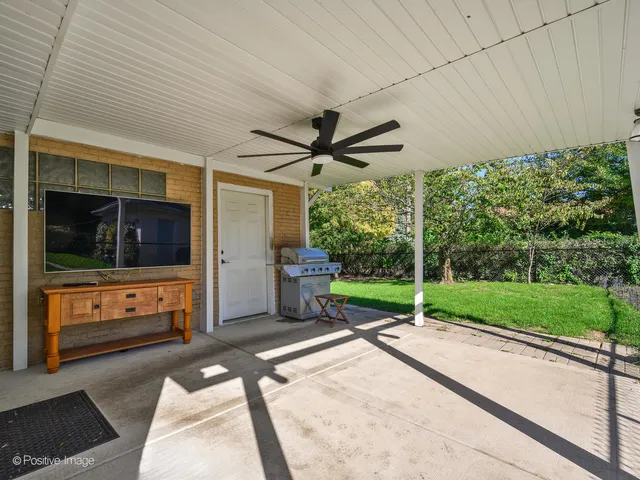 a view of a porch with furniture and a yard