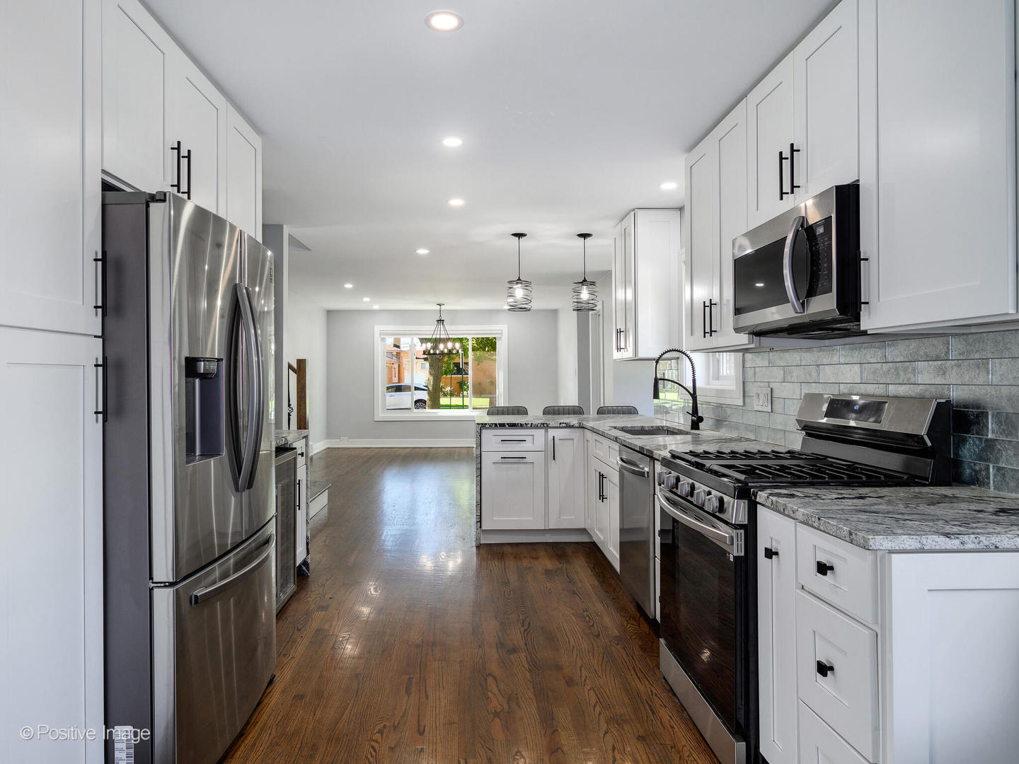 7225 East Prairie Road Lincolnwood, IL 60712 - Photo 9 of 27 a kitchen with stainless steel appliances a refrigerator sink and microwave