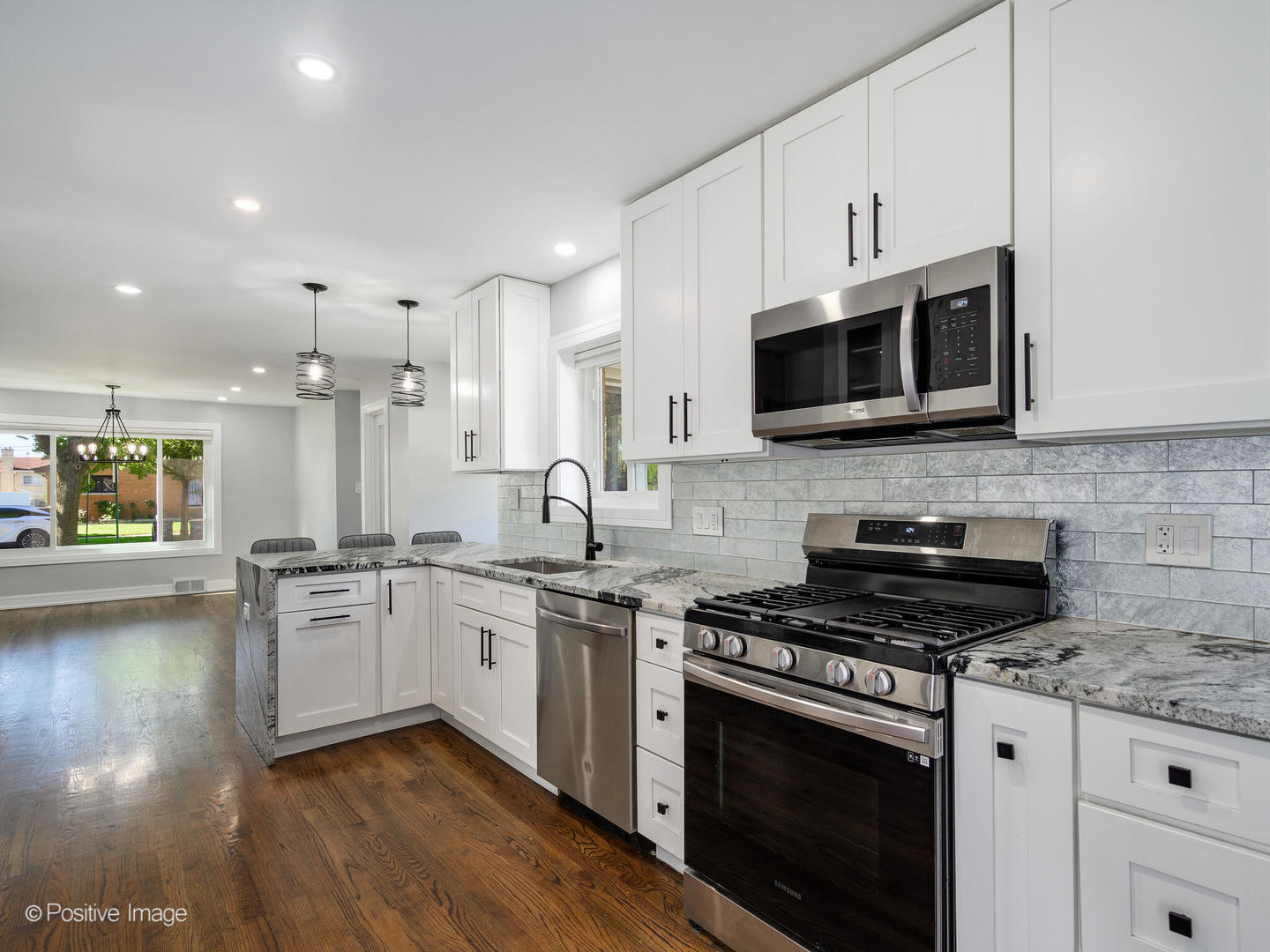 7225 East Prairie Road Lincolnwood, IL 60712 - Photo 10 of 27 a kitchen with stainless steel appliances granite countertop a stove microwave and cabinets