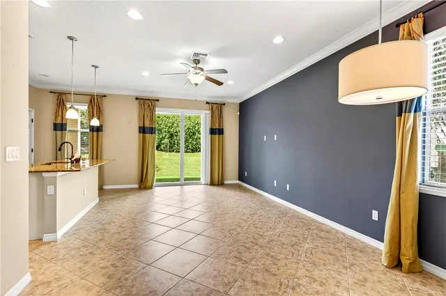 a view of a kitchen with a sink and a refrigerator