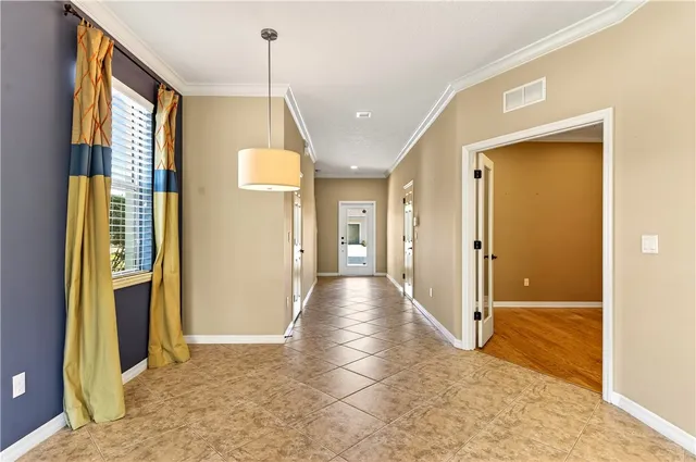 a view of a hallway with wooden floor and a living room