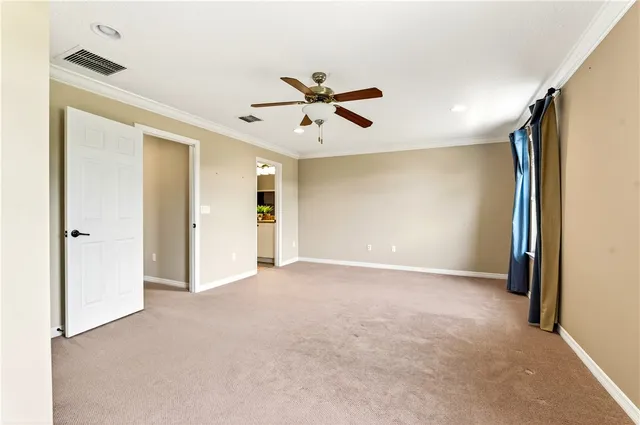 a view of an empty room with a ceiling fan