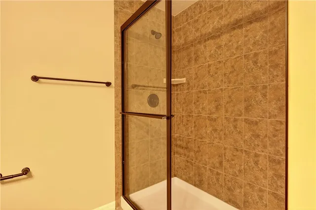 a bathroom with a shower and a glass door