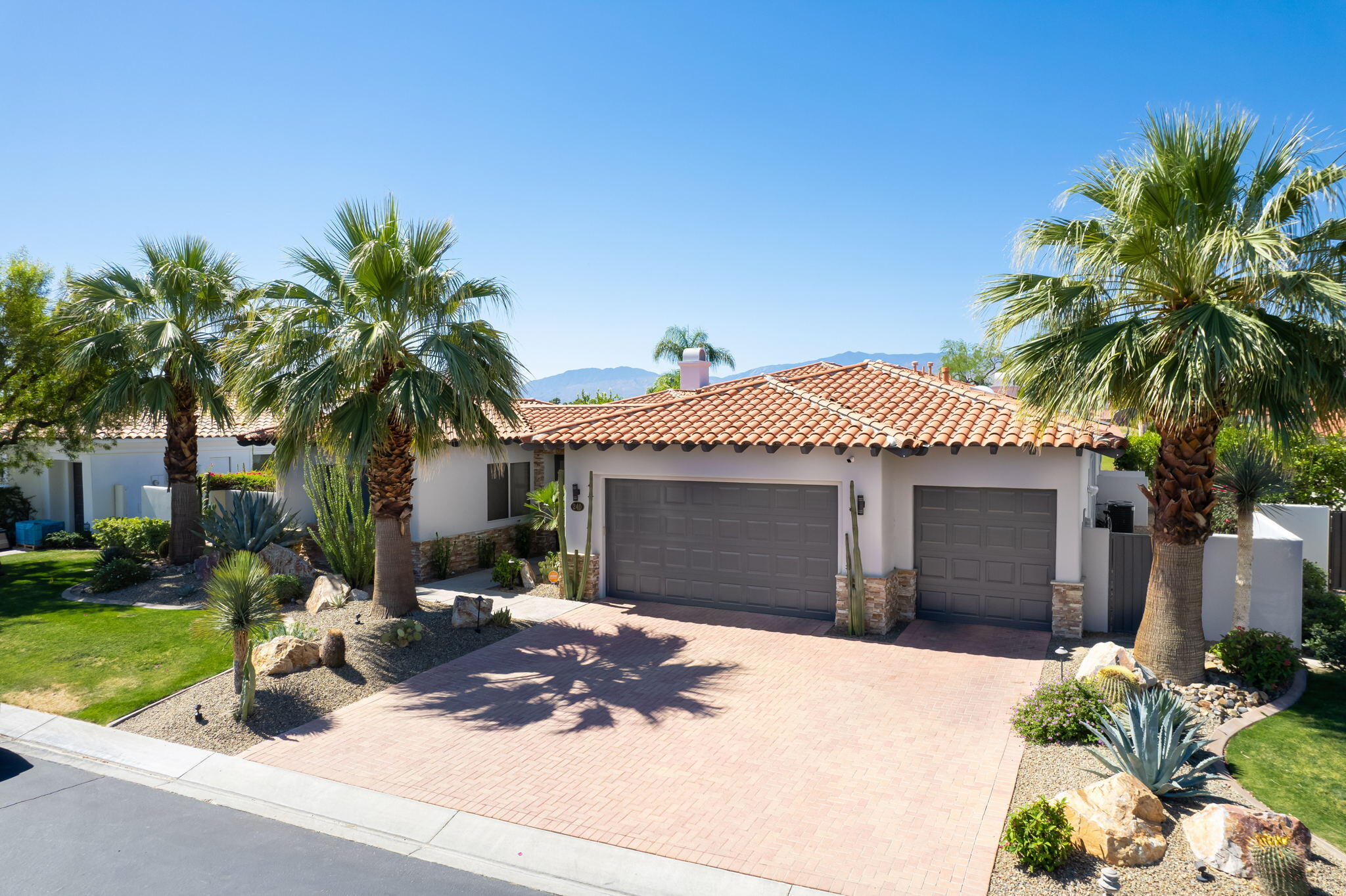 240 Loch Lomond Road Rancho Mirage, CA 92270 - Photo 2 of 2 a front view of a house with yard and garage