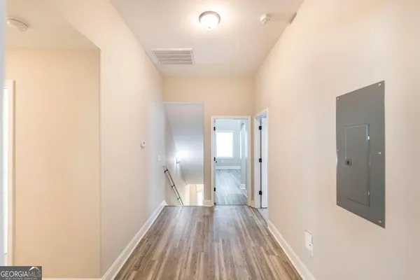 a view of a hallway with wooden floor
