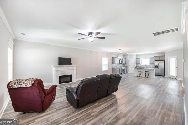 a living room with furniture fireplace and flat screen tv