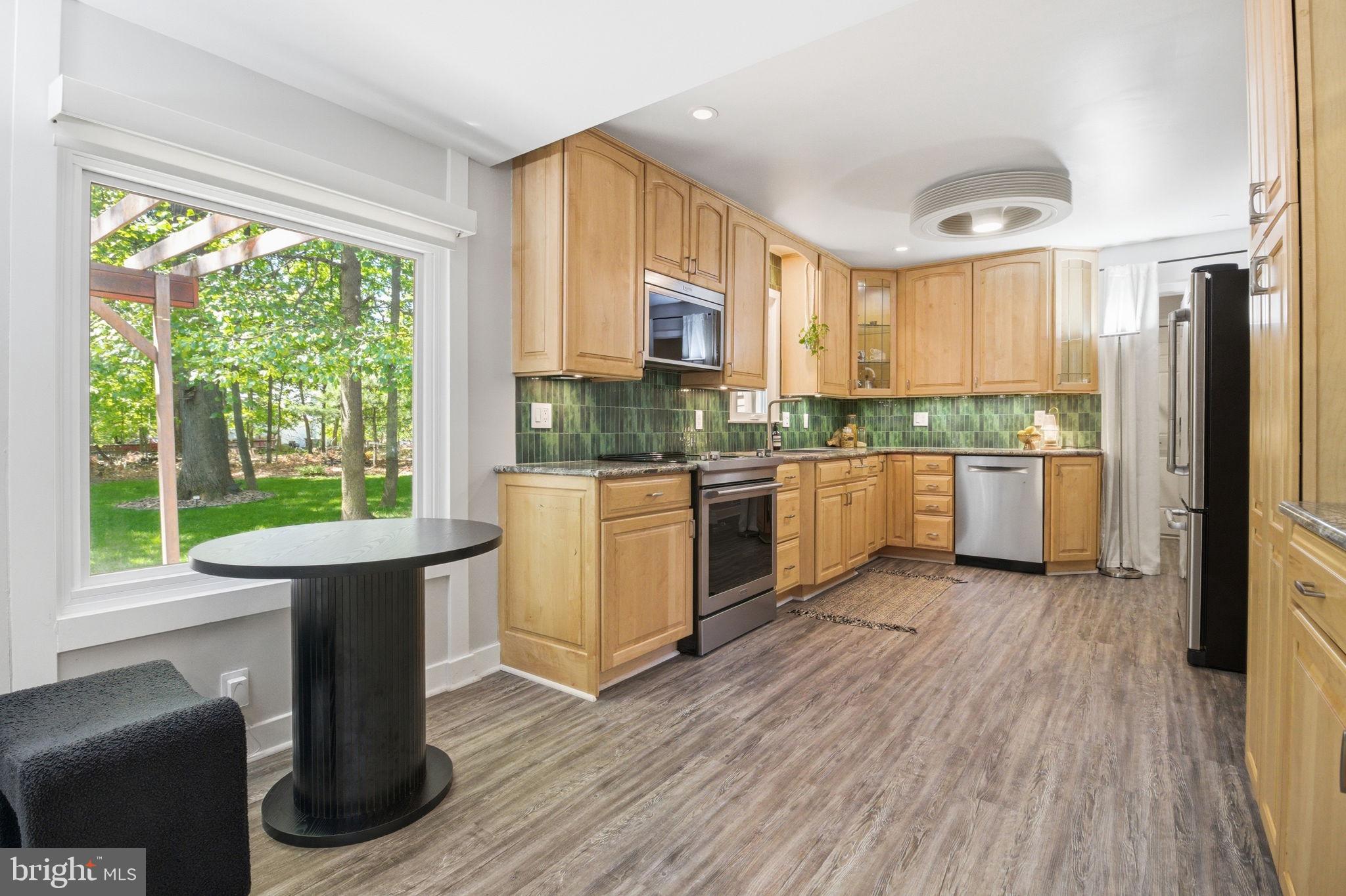 407 Autumn Olive Way Sterling, VA 20164 - Photo 11 of 47 a kitchen with a stove a sink and a refrigerator