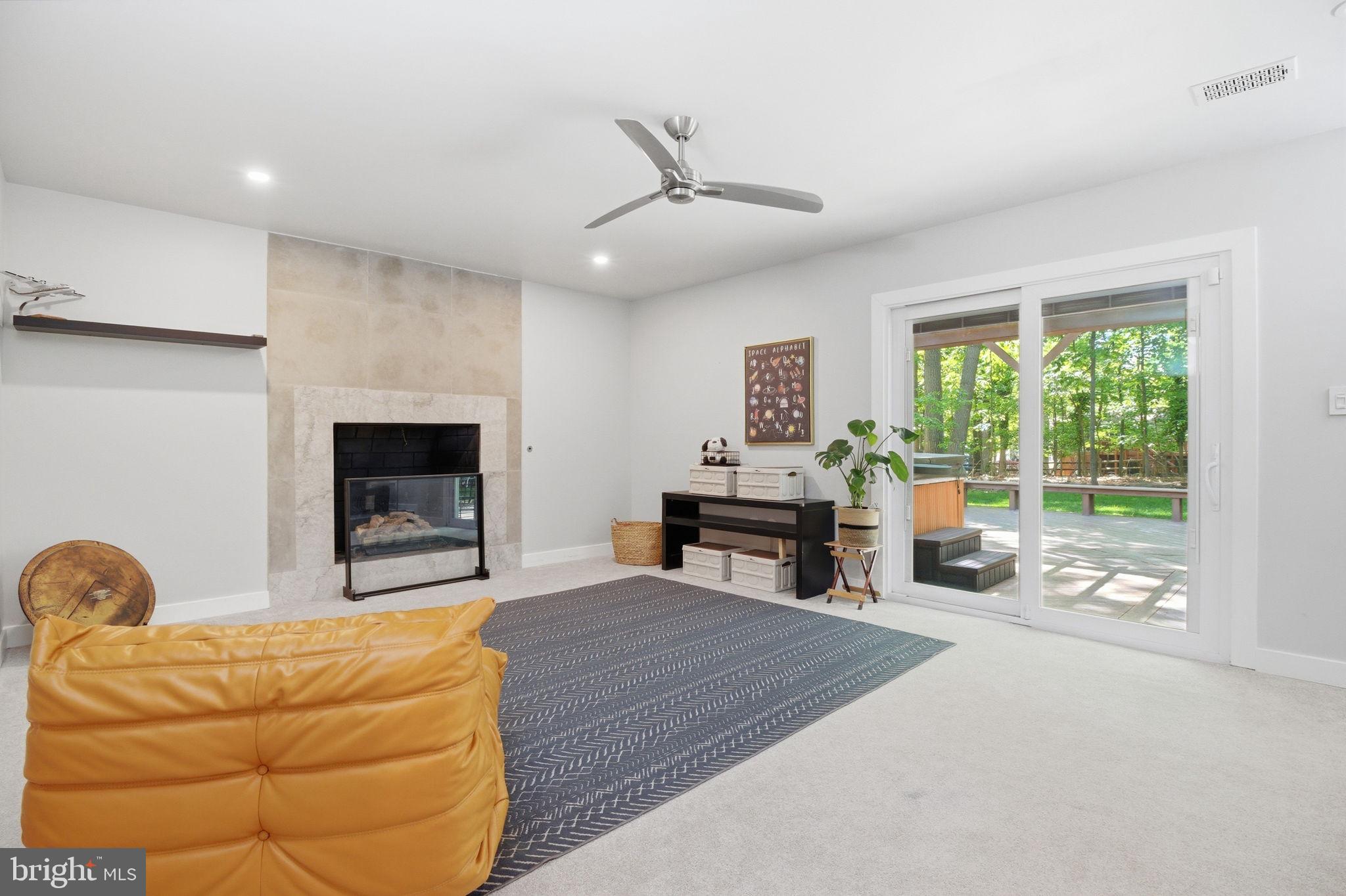 407 Autumn Olive Way Sterling, VA 20164 - Photo 18 of 47 a living room with furniture a fireplace and a flat screen tv