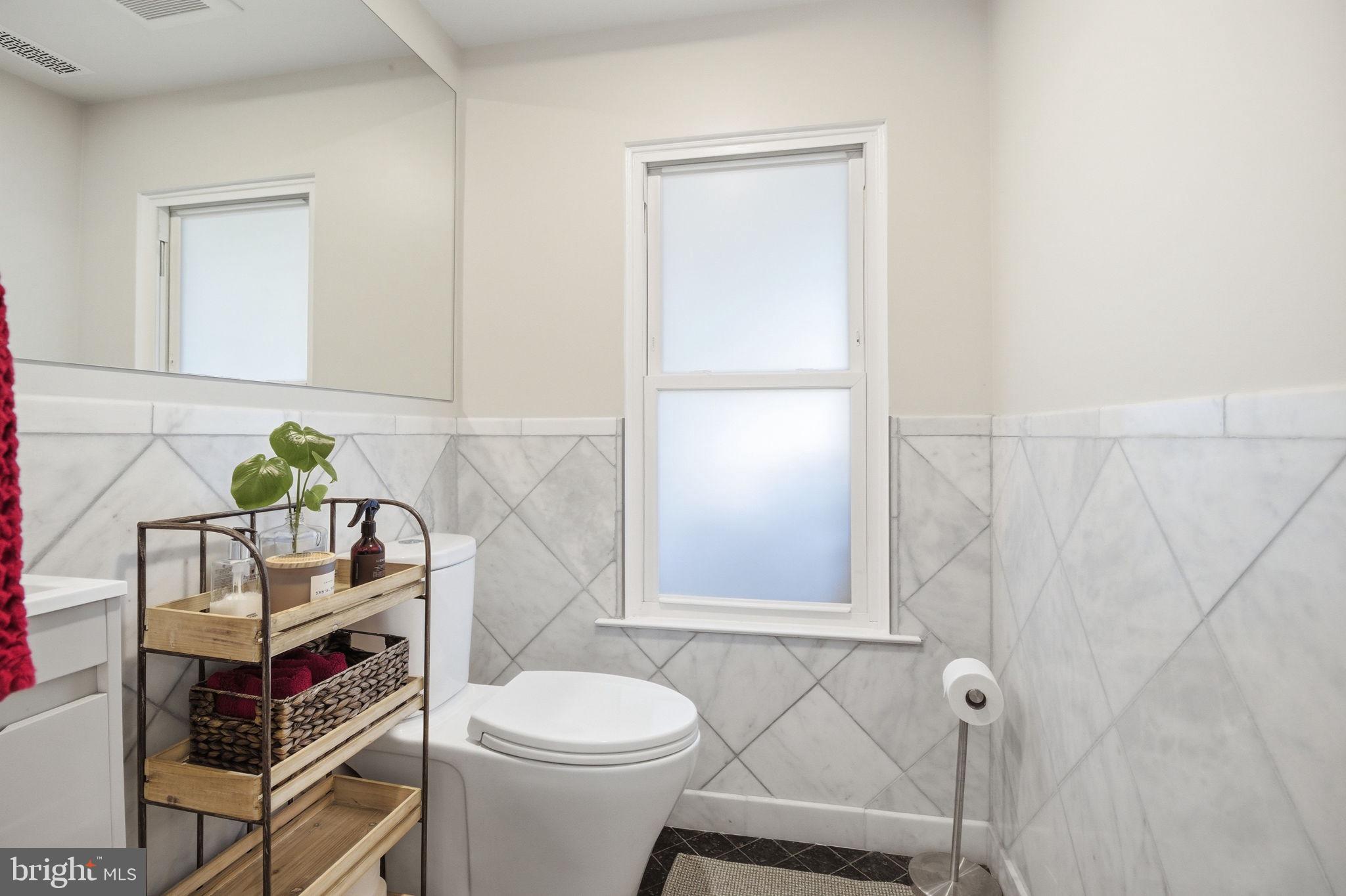 407 Autumn Olive Way Sterling, VA 20164 - Photo 19 of 47 a white toilet sitting next to a bathroom sink