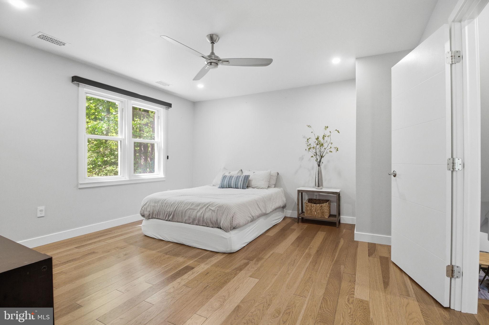 407 Autumn Olive Way Sterling, VA 20164 - Photo 20 of 47 a spacious bedroom with a bed and a chandelier